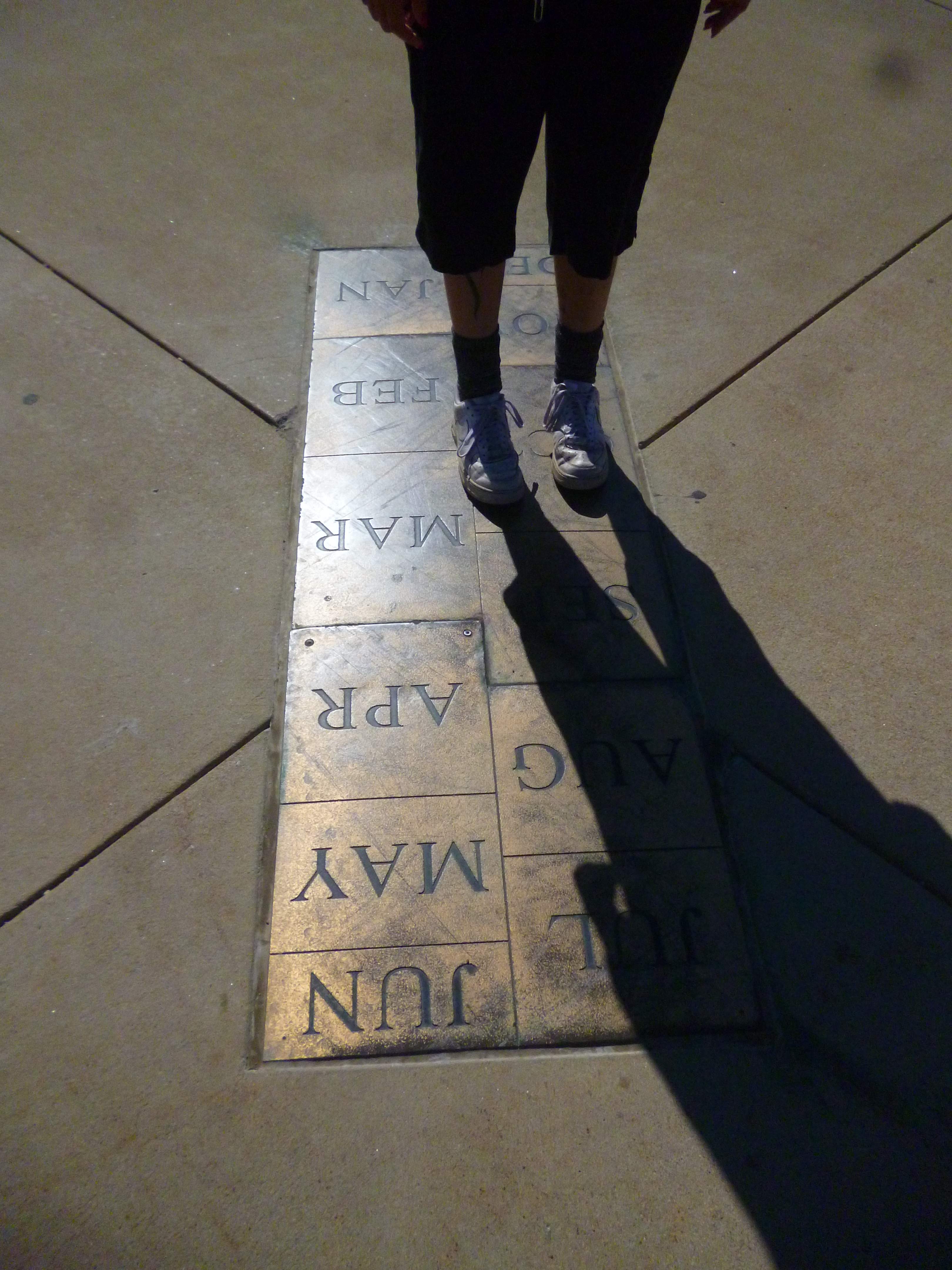 David standing on a grid with month names on each box.