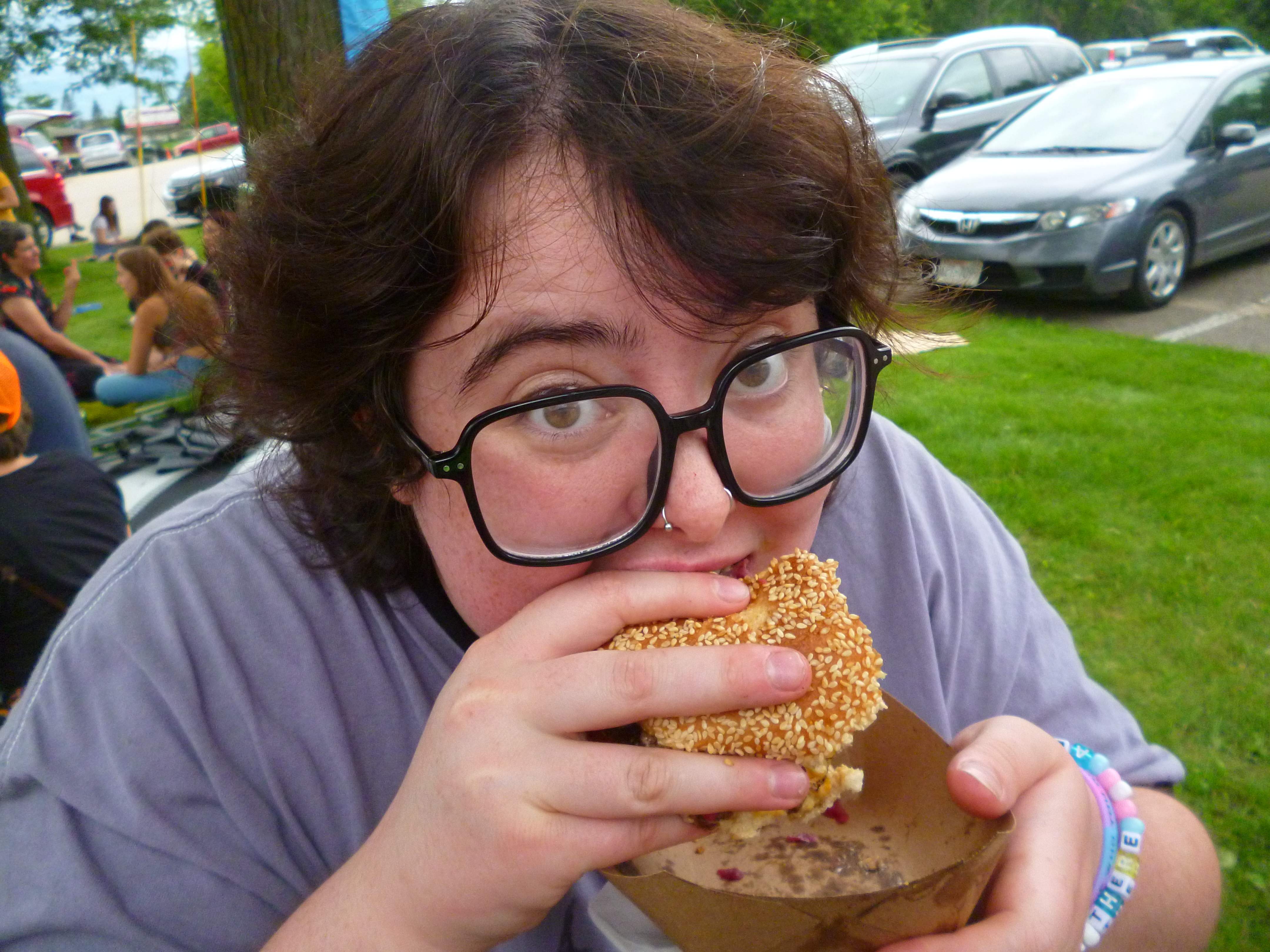 Lucia biting into a burger. YUM.