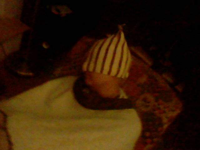 David sleeping with a hat pulled over his face.