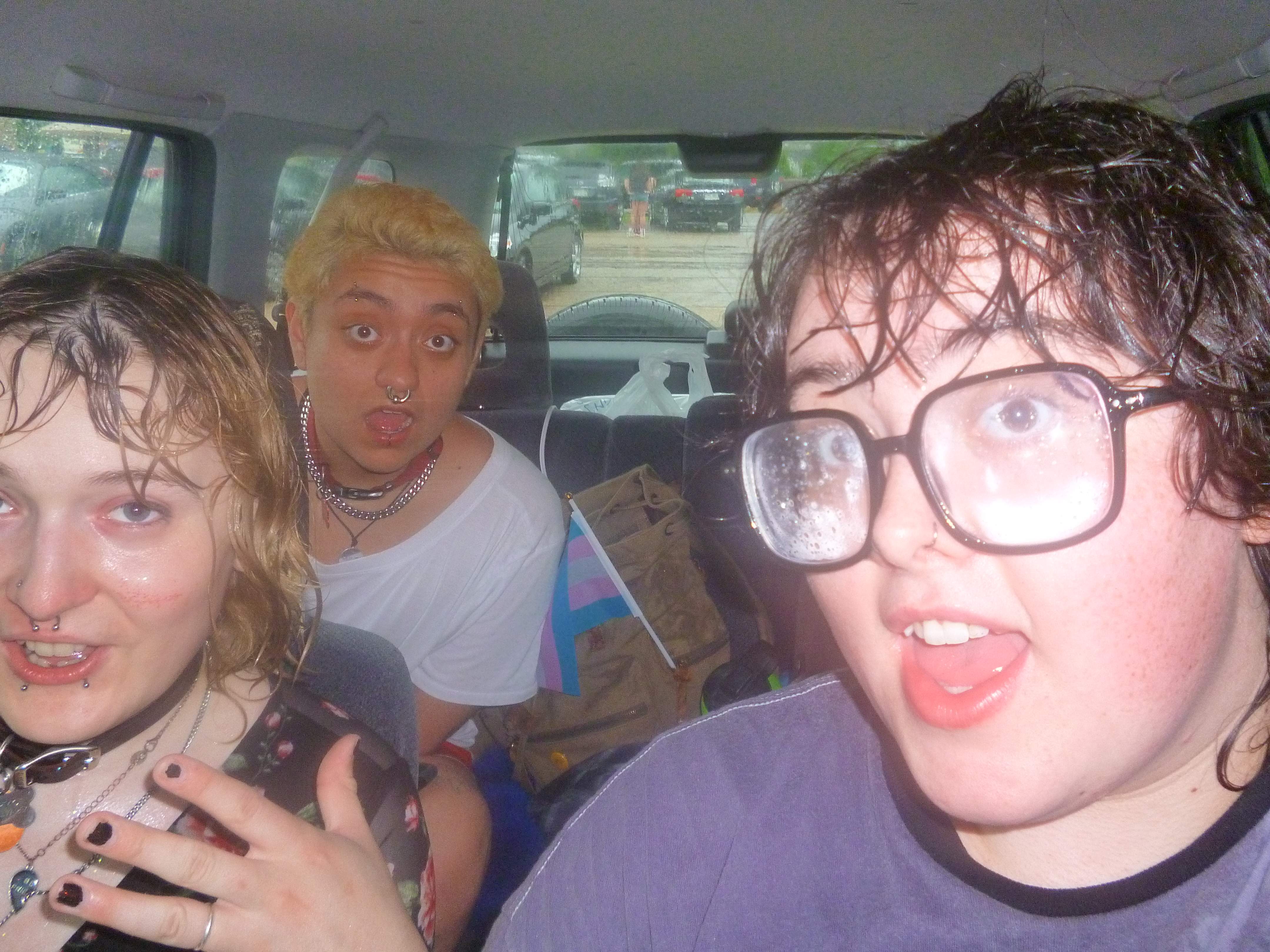 Katie Lucia and David in a car. Katie and Badger got rained on.