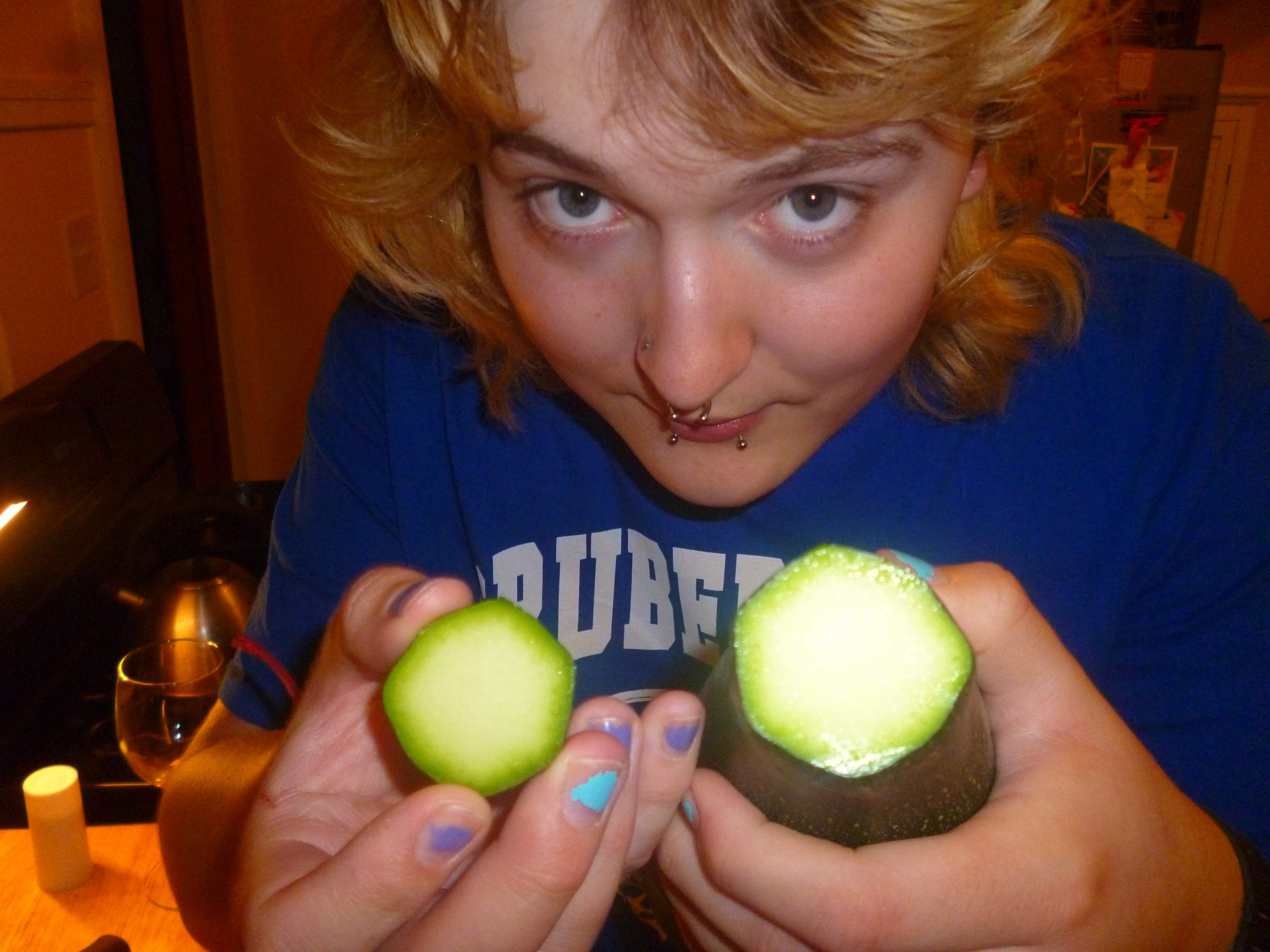 Katie holding up the zucchini with the top cut off.