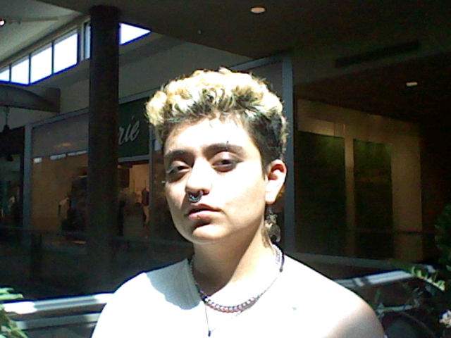 Picture of David under intense overhead sunlight in a dark mall.