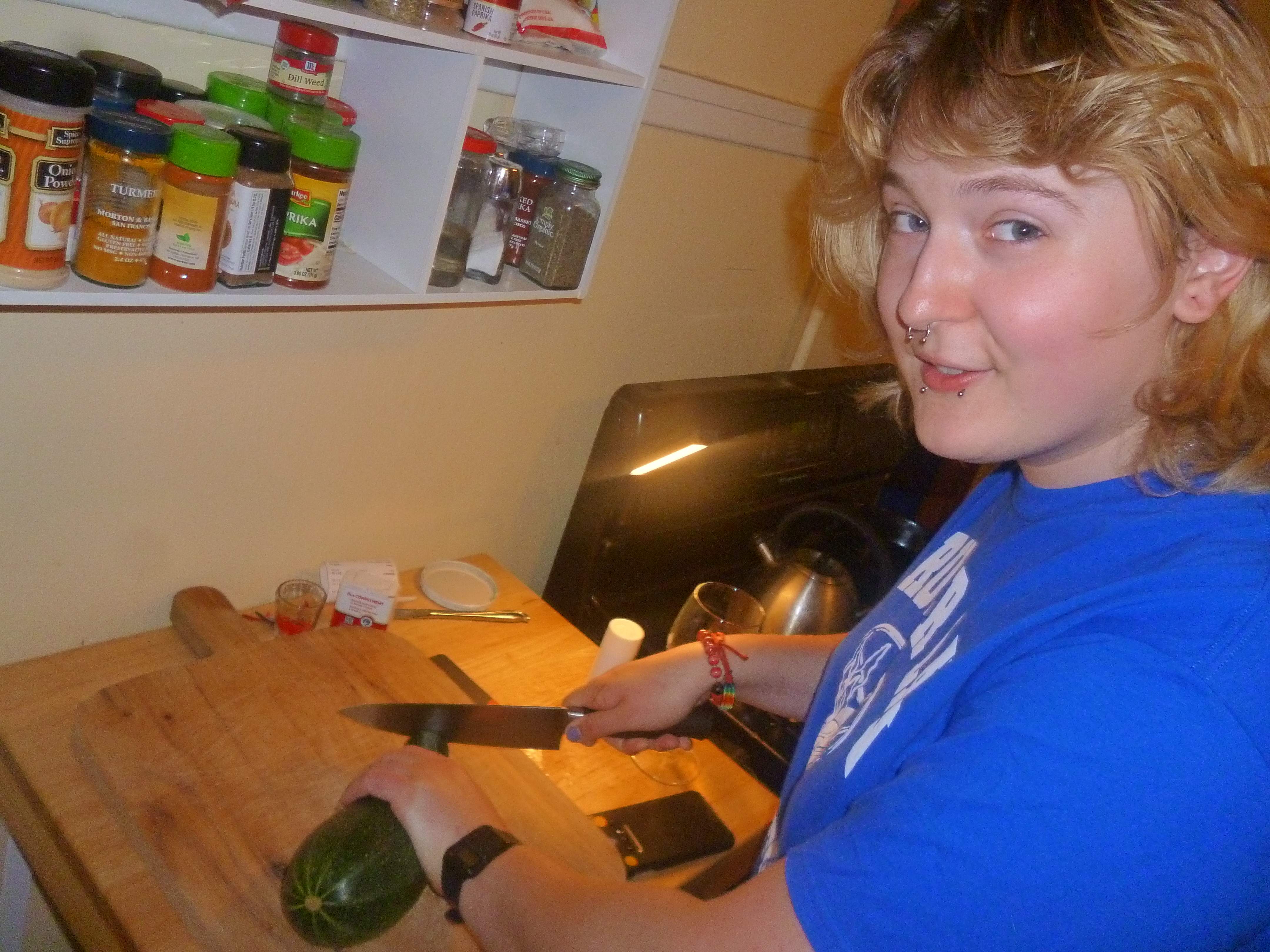 Katie chopping up the zucchini from the garden.