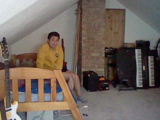 David sitting on the guest bed in our loft.